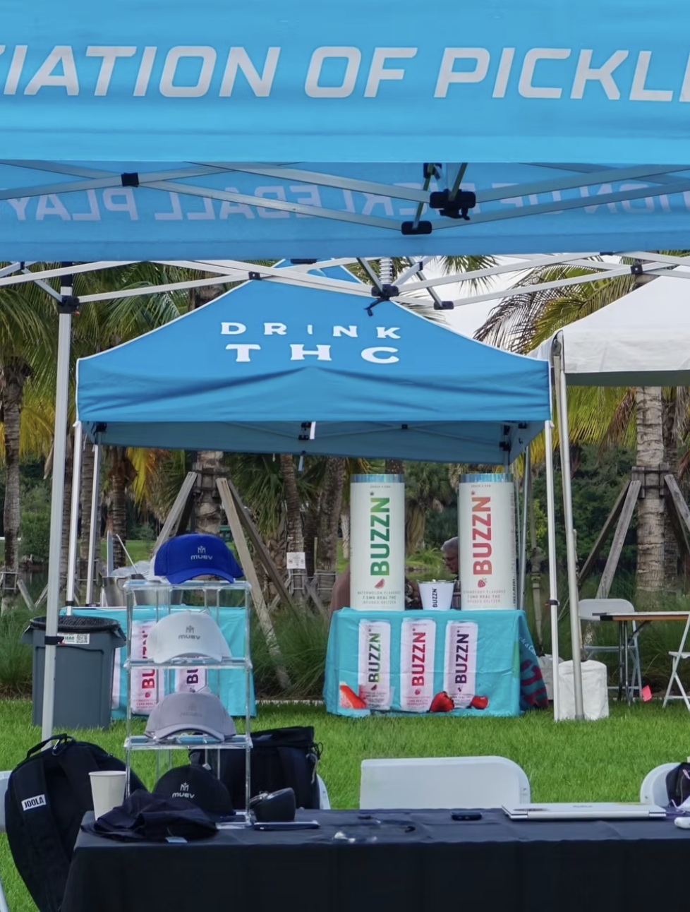 BUZZN field activation tent and product display at an outdoor event in Miami